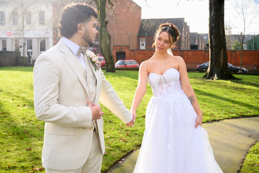 Close up of a groom embracing his bride with a soft-focus background.